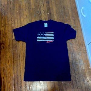 It is a dark blue shirt with an American flag on it and has the word date on it.